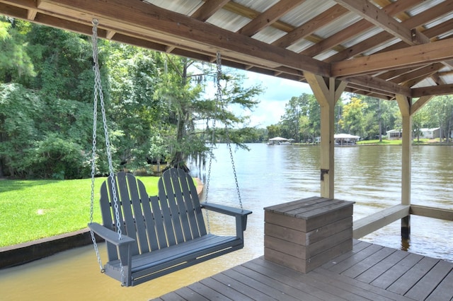 view of dock featuring a water view and a yard