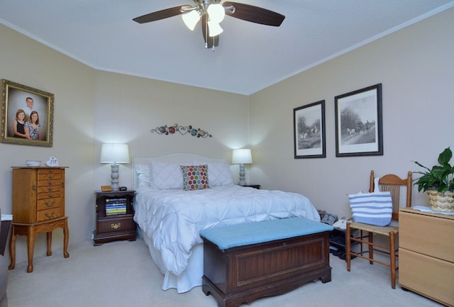 bedroom with ceiling fan, ornamental molding, and light carpet