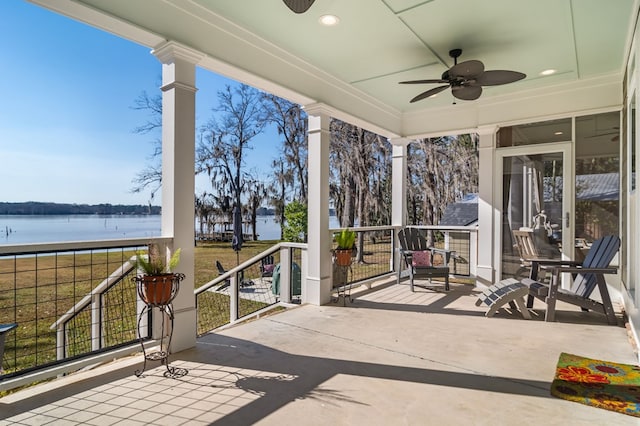 view of patio / terrace featuring a water view and ceiling fan