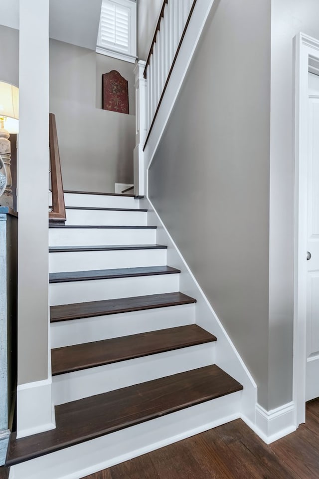 stairs with baseboards and wood finished floors