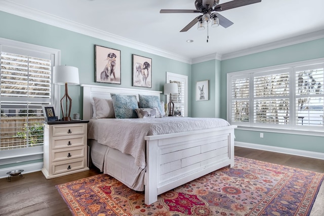 bedroom featuring dark wood-type flooring, ornamental molding, multiple windows, and baseboards