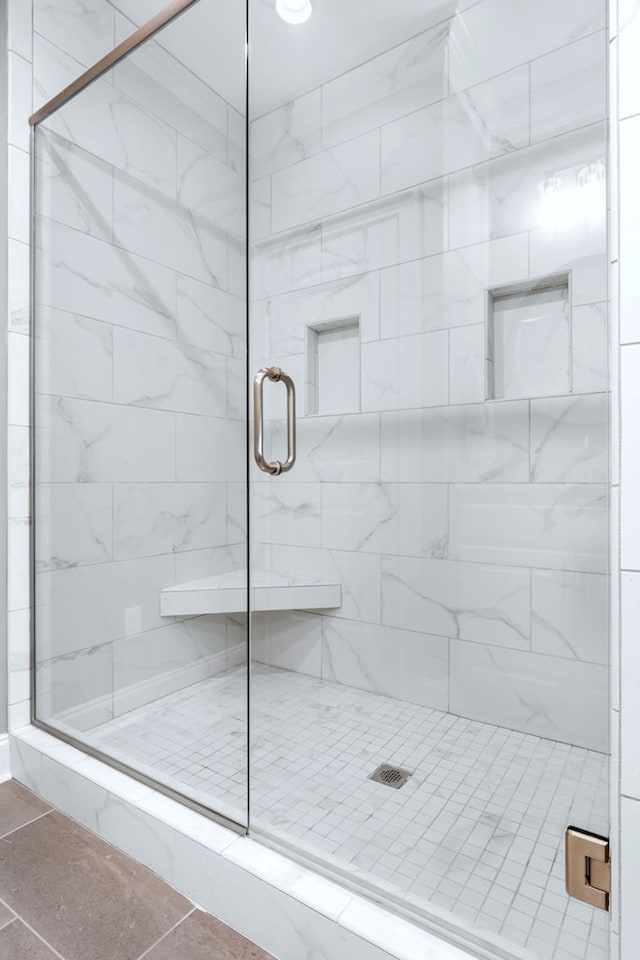 full bath with a shower stall