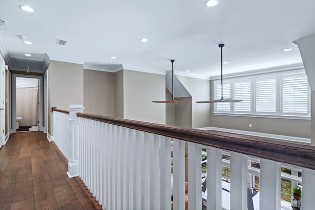 corridor with dark wood finished floors, recessed lighting, visible vents, attic access, and ornamental molding