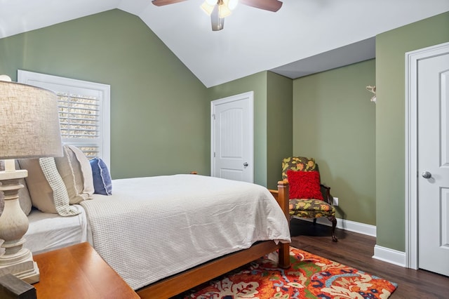 bedroom with vaulted ceiling, dark wood-style flooring, a ceiling fan, and baseboards