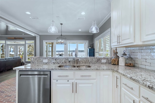 kitchen featuring visible vents, hanging light fixtures, ornamental molding, white cabinets, and dishwasher