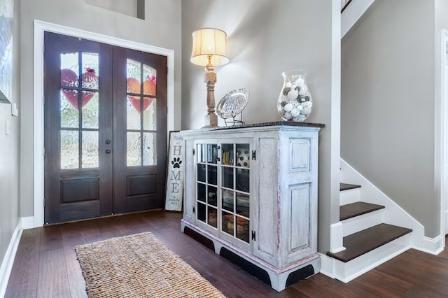 entrance foyer with dark wood-style floors, french doors, stairway, and baseboards