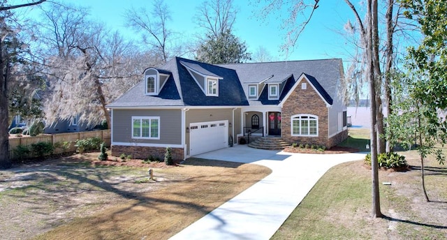 view of front facade featuring driveway, stone siding, fence, and a front yard