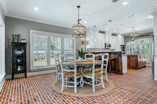 dining room with brick floor, recessed lighting, visible vents, baseboards, and crown molding