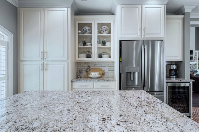 kitchen with light stone countertops, wine cooler, glass insert cabinets, and stainless steel fridge with ice dispenser