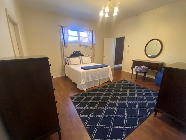 bedroom with crown molding, dark hardwood / wood-style floors, and a notable chandelier