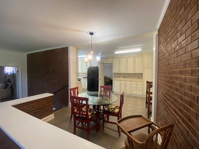 dining area with brick wall and ornamental molding