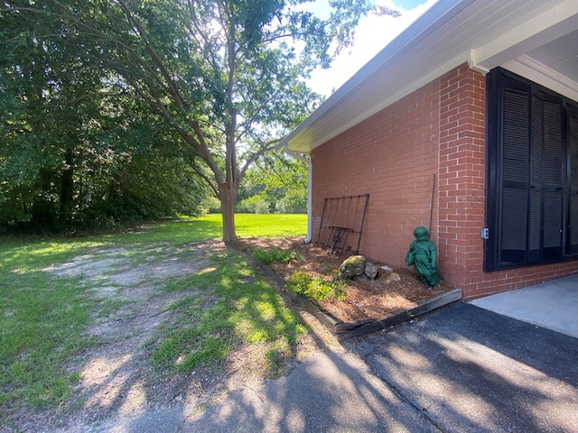 view of property exterior with a lawn