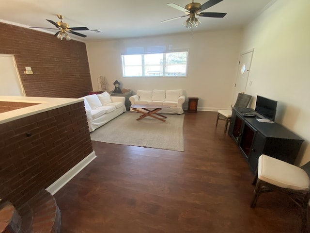 living room with ceiling fan, brick wall, and dark hardwood / wood-style flooring