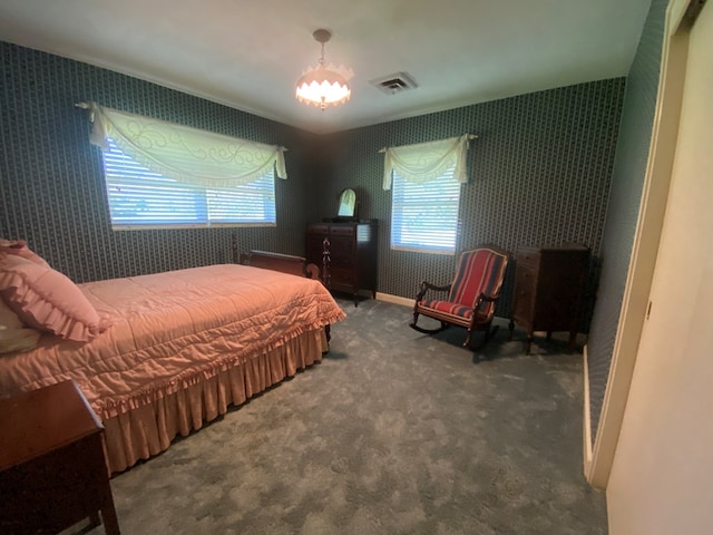 carpeted bedroom with a chandelier