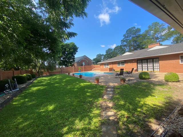 view of yard featuring a fenced in pool and a patio