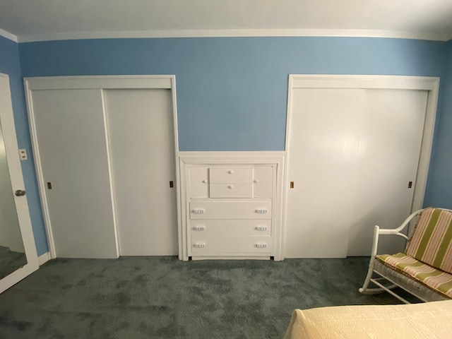 living area featuring dark carpet and crown molding