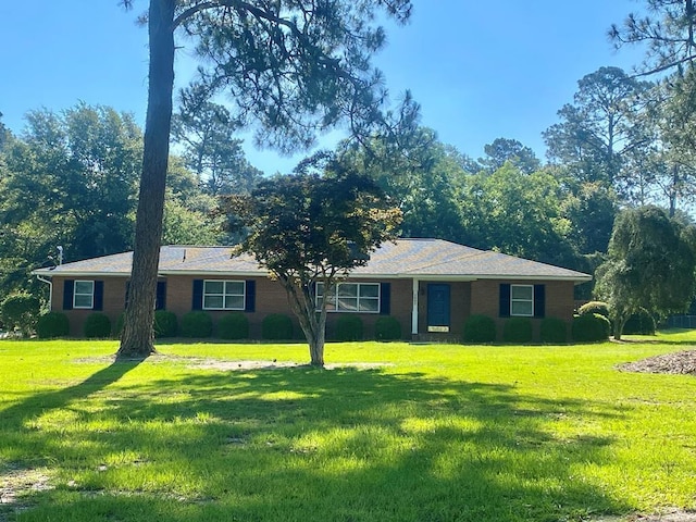 ranch-style home with a front lawn