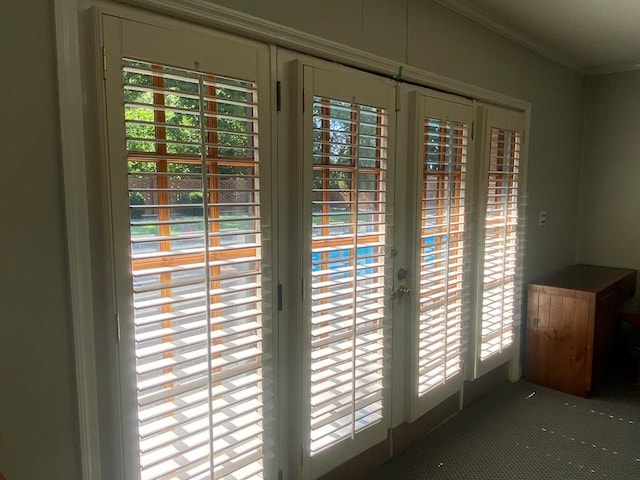 doorway to outside with plenty of natural light, ornamental molding, and french doors