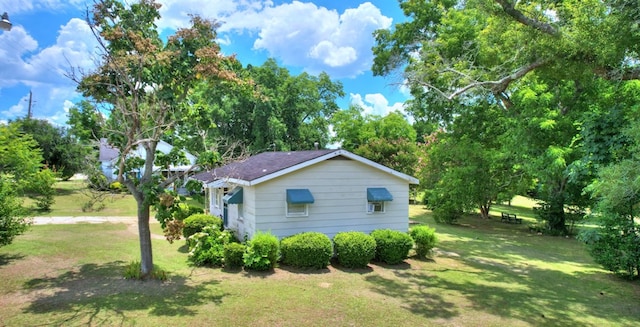 view of home's exterior with a yard