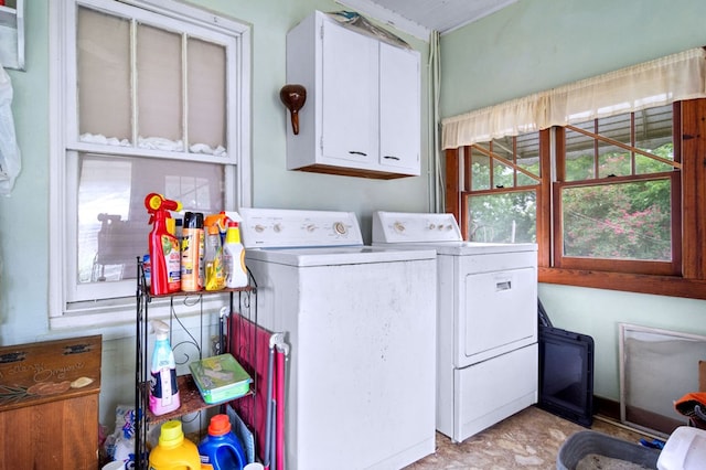 washroom with washing machine and dryer and cabinets