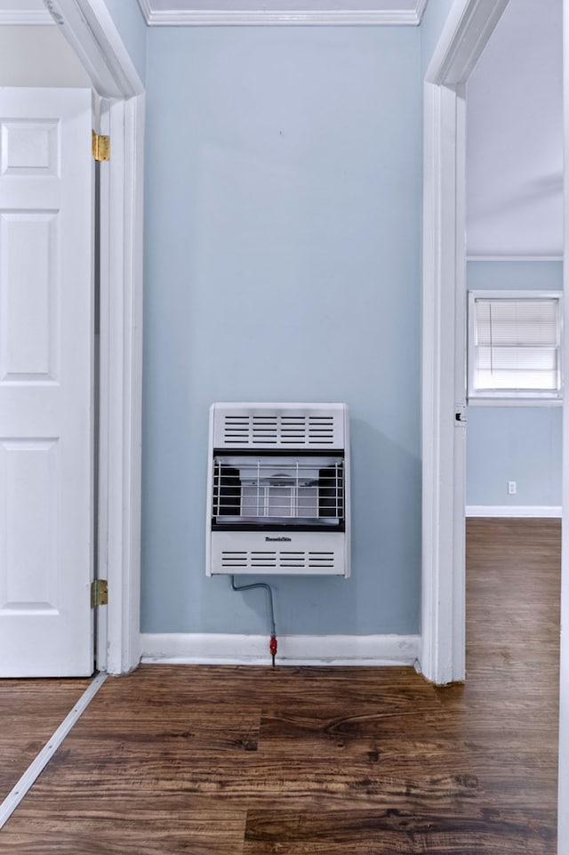 room details featuring crown molding, wood-type flooring, and heating unit