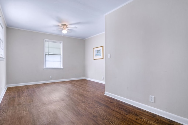 empty room featuring crown molding, dark wood-type flooring, and ceiling fan