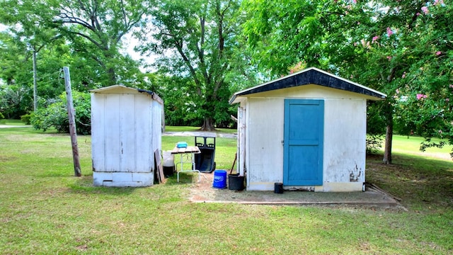 view of outdoor structure featuring a lawn