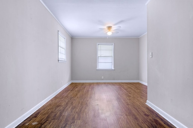 empty room with dark wood-type flooring, ceiling fan, and ornamental molding