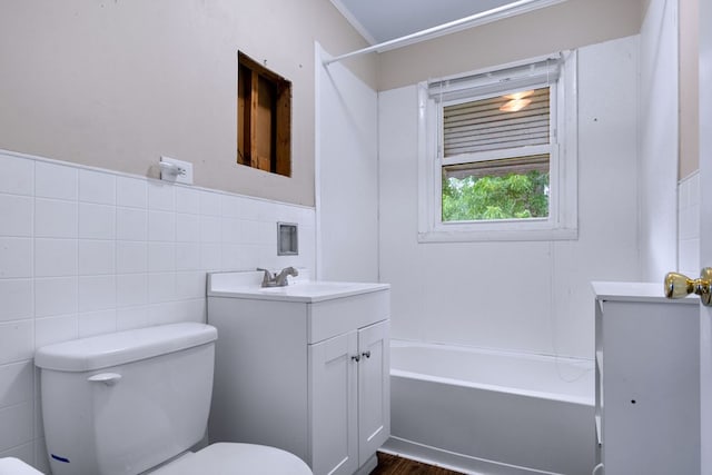 full bathroom featuring wood-type flooring, toilet, vanity,  shower combination, and crown molding