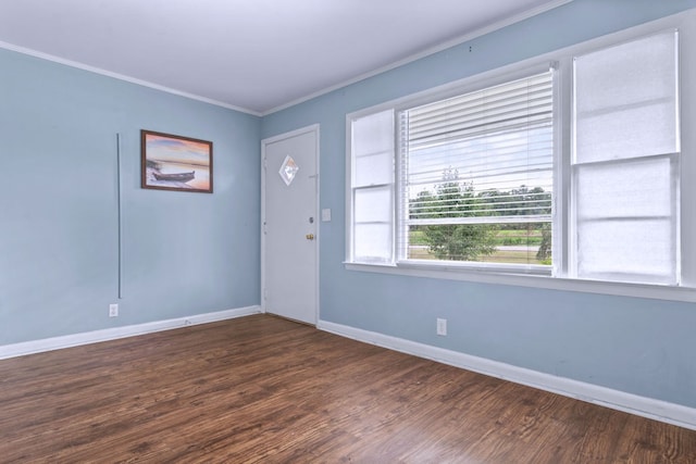 foyer with dark wood-type flooring and ornamental molding