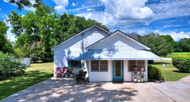 bungalow-style house with a front lawn