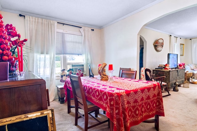 dining area with ornamental molding, light carpet, and a textured ceiling