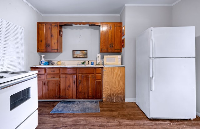 kitchen featuring sink, white appliances, dark wood-type flooring, and ornamental molding