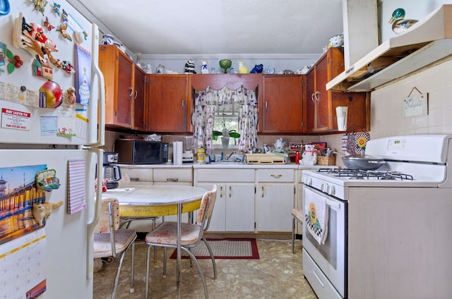 kitchen featuring white cabinetry, white appliances, and crown molding