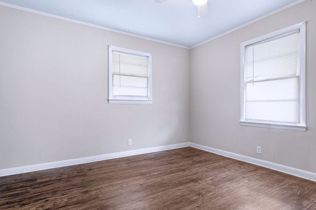 empty room with ceiling fan, ornamental molding, and dark hardwood / wood-style flooring