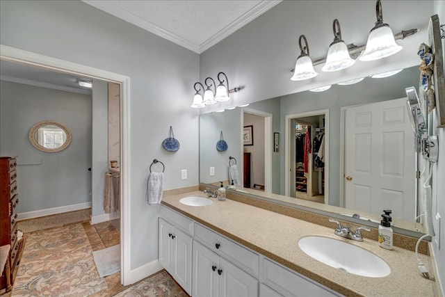 bathroom with vanity, crown molding, and a textured ceiling