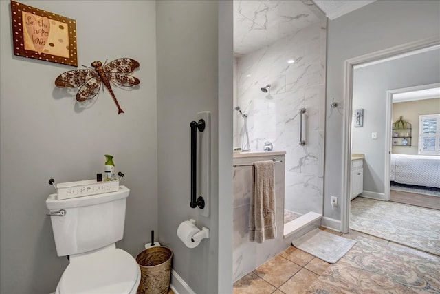 bathroom featuring toilet and a tile shower