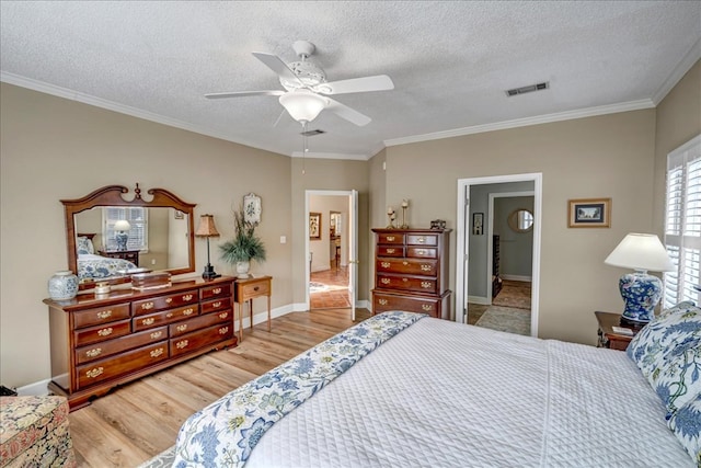 bedroom with ceiling fan, light hardwood / wood-style flooring, ornamental molding, and a textured ceiling