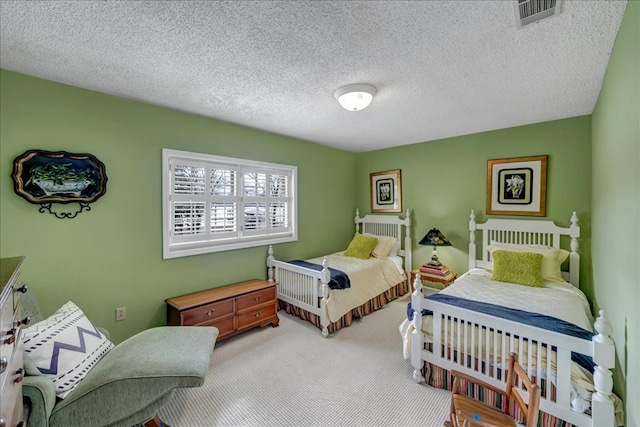 carpeted bedroom featuring a textured ceiling