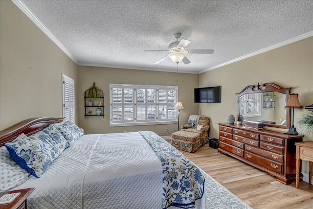 bedroom with crown molding, light hardwood / wood-style floors, and a textured ceiling