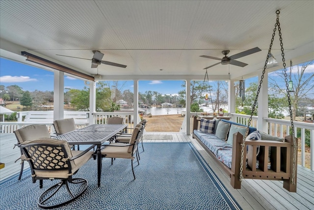 sunroom / solarium with a wealth of natural light and ceiling fan