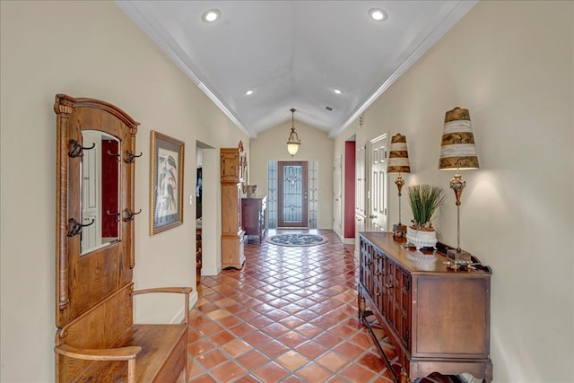 entryway with tile patterned flooring, crown molding, and vaulted ceiling