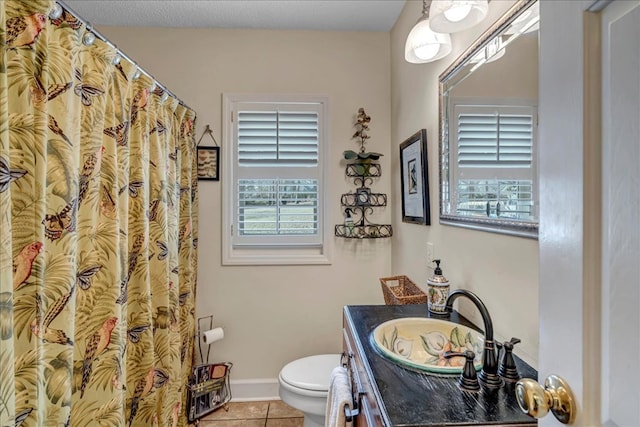 bathroom featuring vanity, tile patterned floors, and toilet