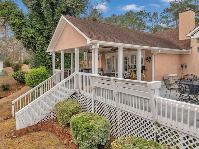 exterior space with ceiling fan and a deck