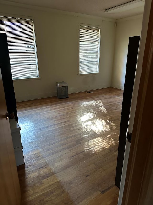 unfurnished room with wood-type flooring