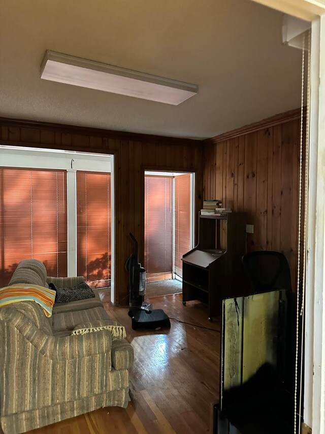 bedroom with hardwood / wood-style flooring and wood walls