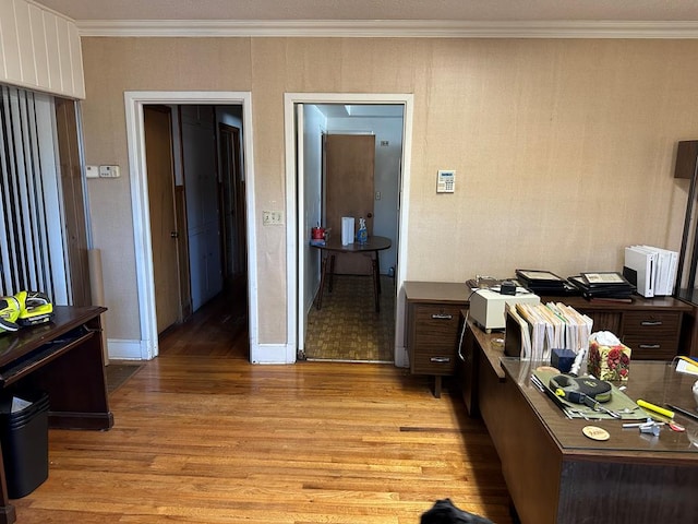 office with ornamental molding and light hardwood / wood-style floors