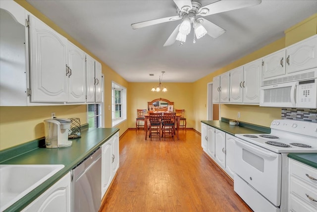 2489 W Ga Highway 30, Americus, GA 31719 - kitchen with white appliances, white cabinets, and a chandelier