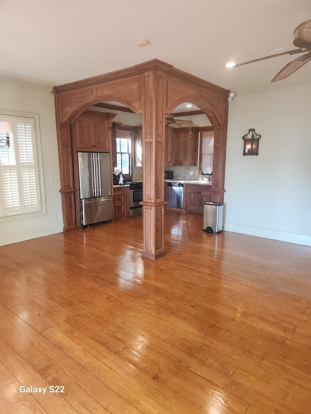 unfurnished living room featuring ceiling fan and light hardwood / wood-style flooring