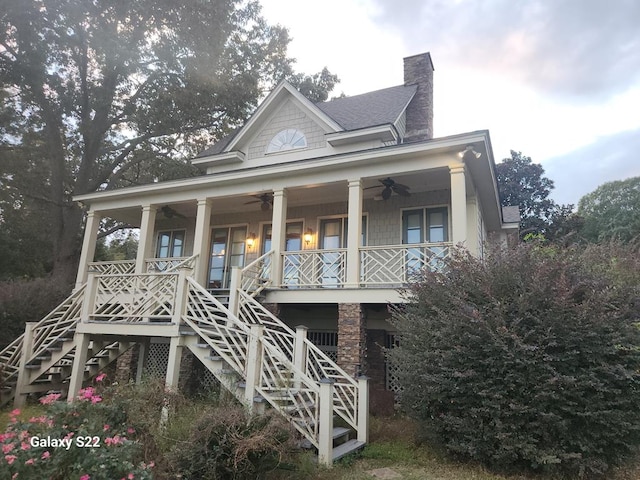 rear view of property featuring covered porch and ceiling fan